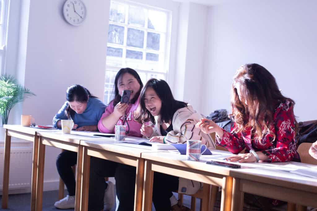 Students enjoying a teacher training programme and English Learning programme in UKG Language's new classroom, in the new school based in Ringwood, UK. The English lessons are fun and interactive. 