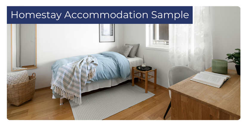 Sample homestay accommodation bedroom with a single bed, desk, chair, side table, and natural light from a window, styled in a clean and modern design.