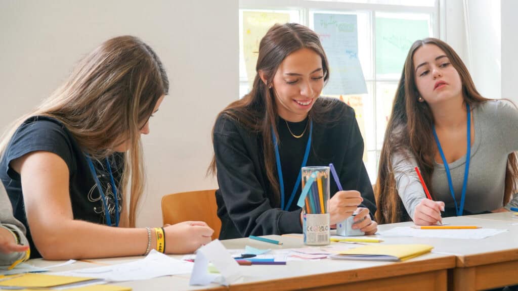 Students learning English safely in a classroom at UKG Language