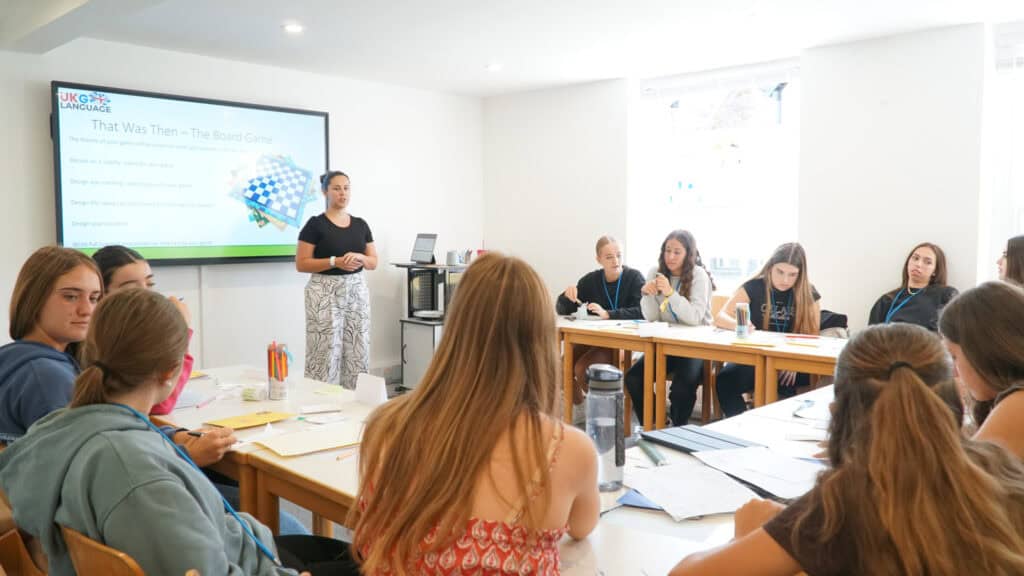 Students learning English safely in a classroom at UKG Language