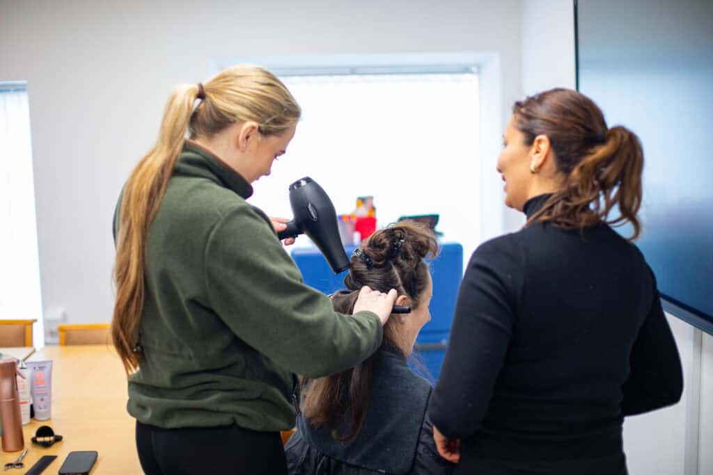 A student learning hair and beauty during their time at UKG Learning, building their vocational skills in a low pressure environment